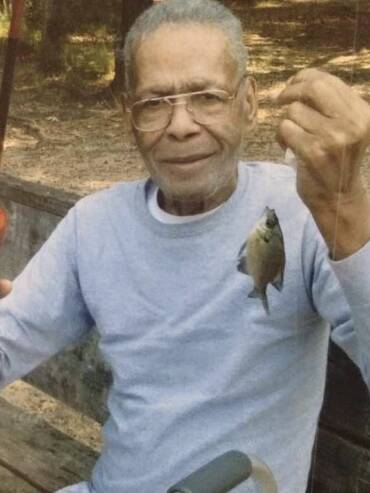 Man holding fishing rod and small fish.
